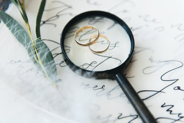 Wedding calligraphy and decor.Inspiration. Wedding invitations, envelope, cards, printing, magnifying glass, rings. Selective focus