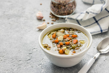 Slow cooker lentil spinach soup. Selective focus, space for text. 