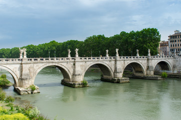 Fototapeta na wymiar St. Angelo Bridge, built by the Roman Emporer Hadrian, is a pedestrian bridge. Spanning the River Tiber., it was built in 134 A.D., with travertine marble fascias