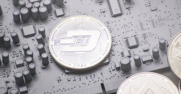 Perspective crypto-currencies: Dashcoin coins on a printed circuit board of gray color.