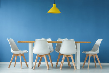 Chairs, table against blue wall
