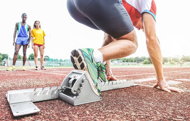 Runner using starting block to start his run on race track