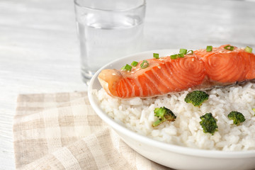 Fish fillet served with rice and broccoli in plate