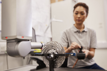 Female Engineer Uses CMM Coordinate Measuring Machine In Factory