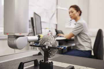 Fototapeta premium Female Engineer Uses CMM Coordinate Measuring Machine In Factory