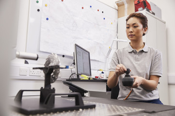 Female Engineer Uses CMM Coordinate Measuring Machine In Factory © Monkey Business