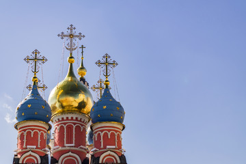Fototapeta na wymiar Gold and blue dome of Church of St. George on blue sky background in Moscow Russia
