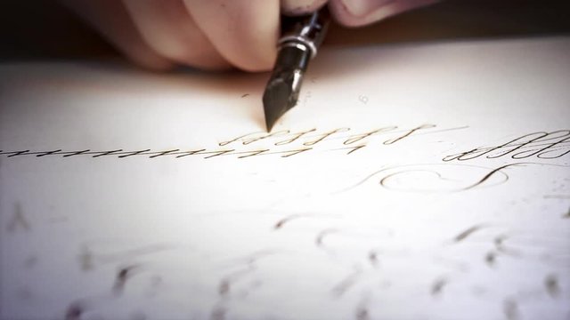 Macro view of old-fashioned handwriting with fountain pen and ink, male hand writing letters on paper, visual effects and computer generated imagery