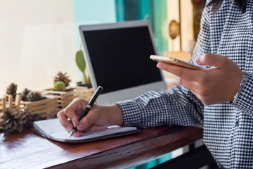  businesswomen using cellphone working in coffee shop.The concept of remote work business lady.