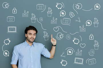 Important information. Clever professional accountant feeling confident while making a report for his employer