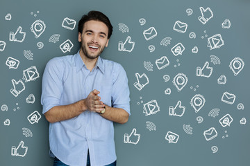 Success. Cheerful young successful blogger feeling happy and laughing while reading funny messages...