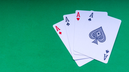 Closeup of playing cards isolated with a green background.