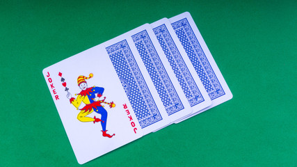 Closeup of playing cards isolated with a green background.