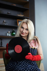 beautiful woman in a dress with vinyl records
