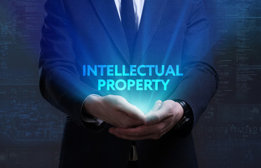 Business, Technology, Internet and network concept. Young businessman working on a virtual screen of the future and sees the inscription: Intellectual property