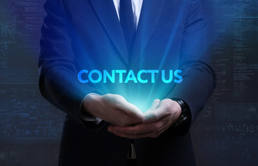 Business, Technology, Internet and network concept. Young businessman working on a virtual screen of the future and sees the inscription: Contact us