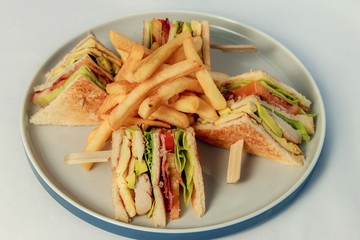 Tasty Club sandwich with meat bacon tomato cucumber and herbs
