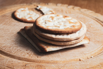 Crackers Stacked on Vintage Bread Board