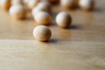 Fototapeta na wymiar Raw Soya Beans on Light Wood Table