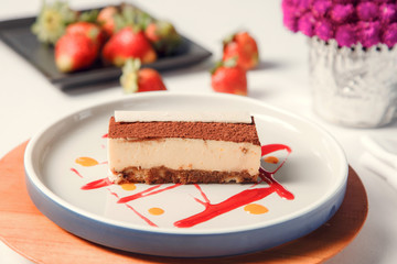 Delicious tasty piece of tiramisu on white plate