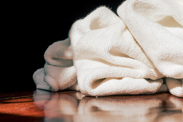 white towel with sunlight shining into parquet floor in the dark