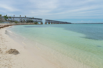 USA, Florida, Ancient overseas railway bridge ruins in tropical clear water at beach
