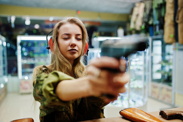 Shooting at the shooting range.The woman at the shooting range shot from gun.