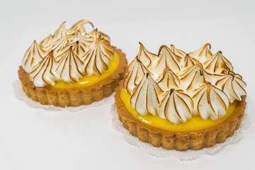 Yummy Lemon Meringues- isolated, studio shot of two lemon meringue tarts 