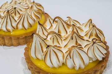 Sweet Peaks-isolated, studio shot of two lemon meringue tarts, with stiff peaks  - 200547738