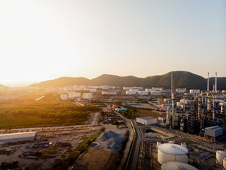 Aerial view of steel pipe oil refinery plant, power plant at sunset sky for industry concept.