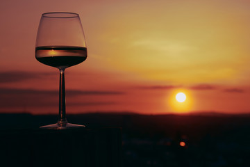 Wine glass in the sunset in the vineyards in Mainz 