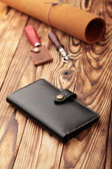 Black leather wallet.Genuine leather craft object with tool using for wallet.DIY tools.Hand crafted wallet