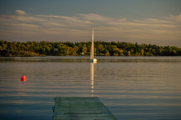 Lonely sailing boat at twilight