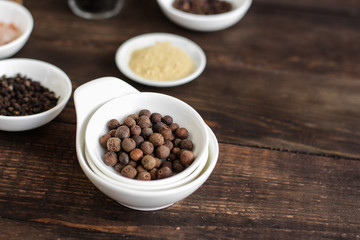 Spices and herbs. Variety of spices and herbs on a dark wooden surface