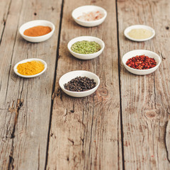 Spices and herbs. Variety of spices and herbs on a dark wooden surface