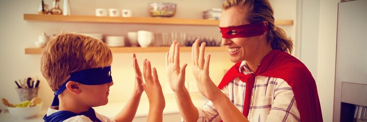 Mother and son playing super heroes