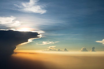 Beautiful sunset above clouds through aircraft window onto jet engine