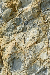The texture of the surface rocks with an orange color under daytime sunlight