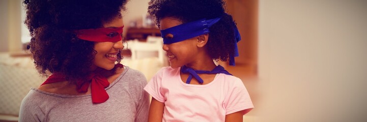 Mother and daughter playing superwoman