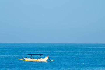 Naklejka premium Traditional bali fishing boat on the sea in Nusa Dua, Bali, Indonesia.