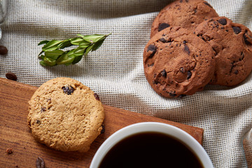 Breakfast background with mug of fresh coffee, homemade oatmeal cookies, grind coffee