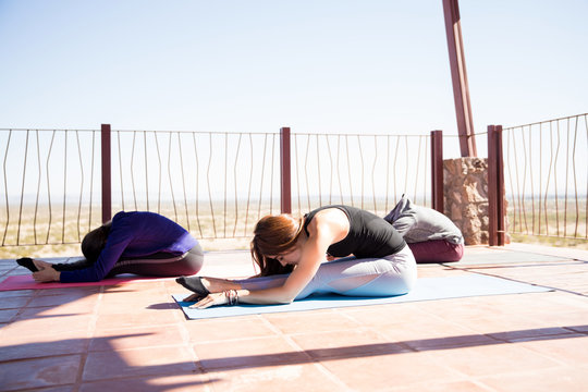 Woman doing seated forward bend yoga