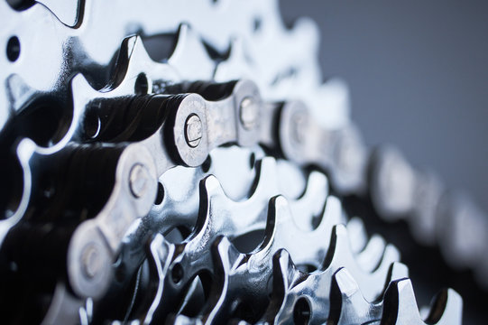 New rear mountain bike cassette with chain on the black background close up