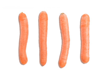top view of carrots on white background arranged in a geometric orderk, columns