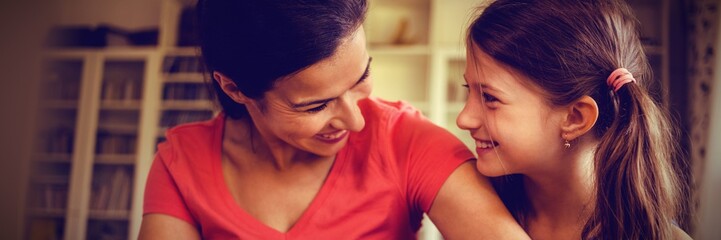 Close up of smiling mother and daughter looking at each other