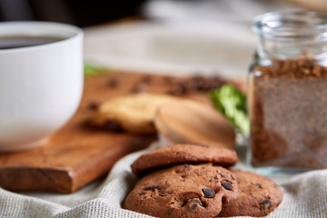 Open jar of instant coffee arranged on woden table, top view, close-up, selective focus.