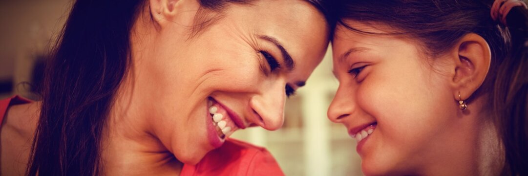 Smiling Mother And Daughter Looking Face To Face