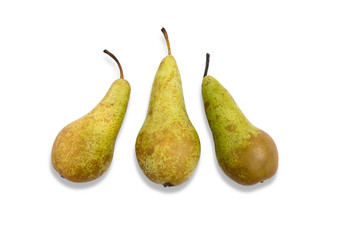 top view of three pears on white background, arranged artistically