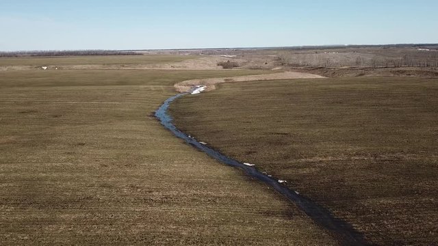 Stream in the field, Aerial view. Ryazan Region landscape. Russia. Spring nature