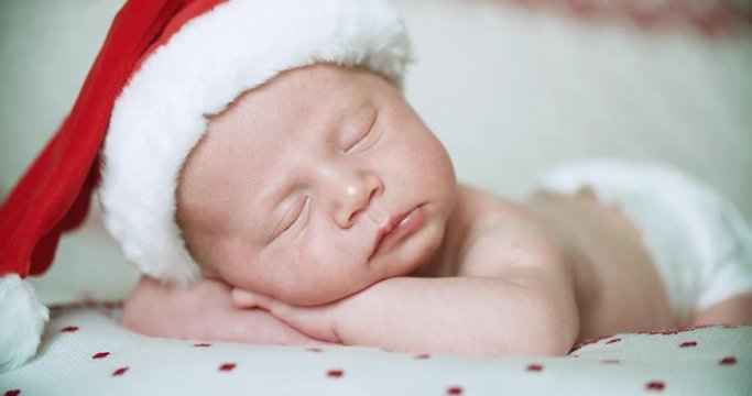 Close up, little baby sleep with Santa Claus hat